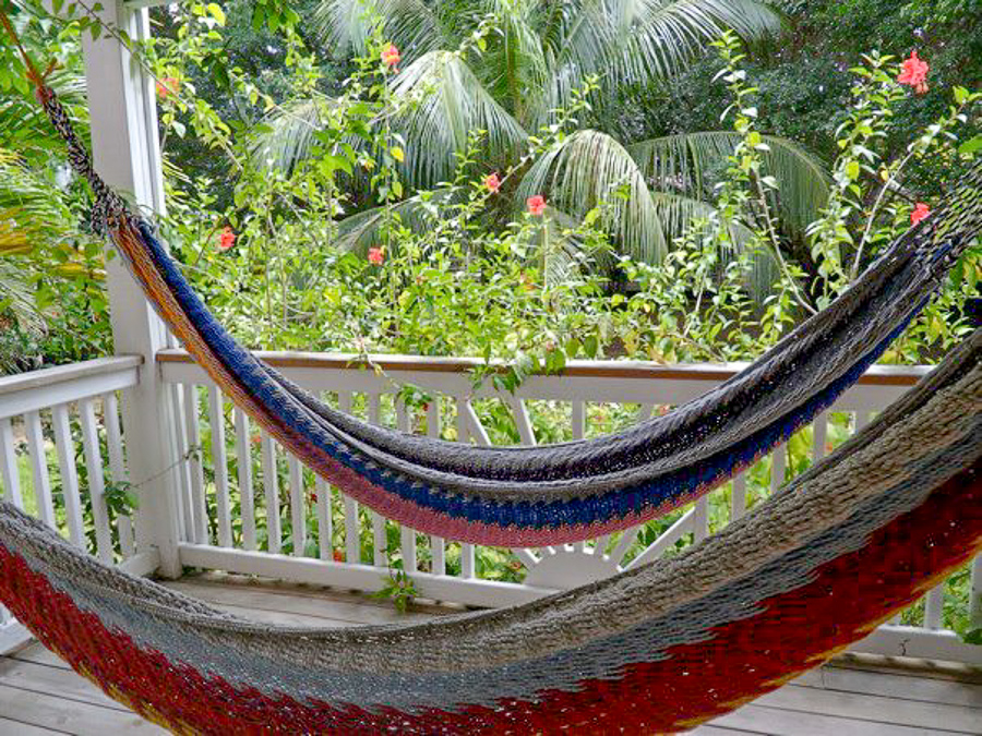 double hammocks on a balcony at Henry Morgan Courtyard grounds in West Bay in Roatan, Honduras