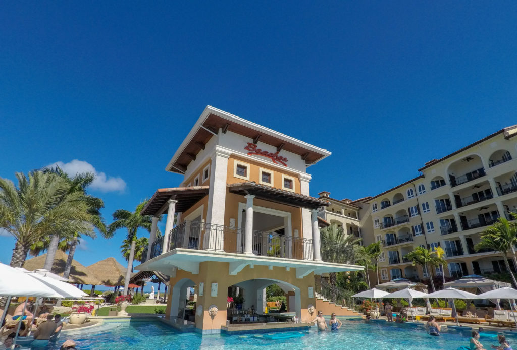 Swim up bar in Italian Village pool and Beaches marque sign. What To Expect When You Arrive at Beaches Turks and Caicos Resort. Here's the low down on what you need to know #beachesresorts #beachesturksandcaicos #beachesresorts #turksandcaicos #allinclusiveturksandcaicos #pls #providenciales #beachesmoms #beachvacations #allinclusivebeachvacations #familyallinclusive #bestallinclusive #familytravelblogger #bestfamilytravleblogger #femaletravelblogger #torontomom