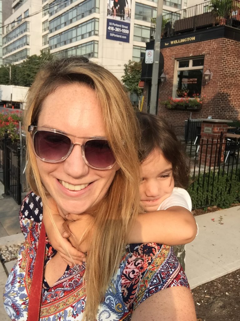 Mom carries boy on back