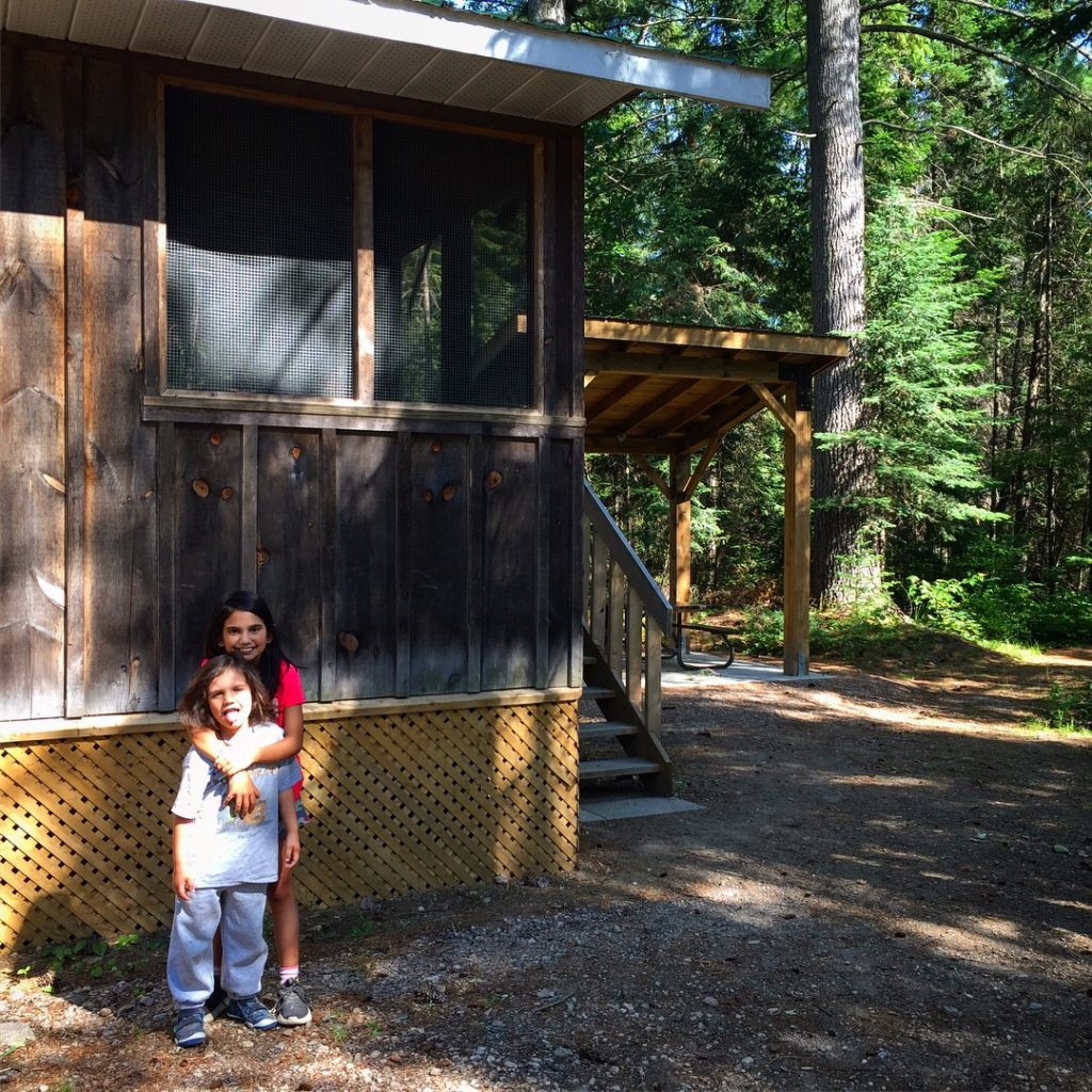 my kids outside the cabin at Bonnechere