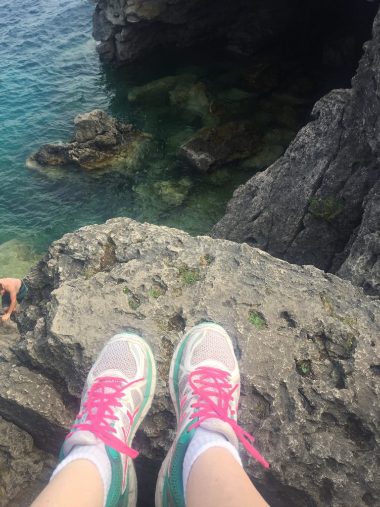 feet over ledge at grotto