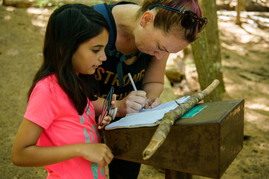 Epic Hikes With Kids - BARRON CANYON TRAIL, signing guest book #discoverON #exploremore #barroncanyontrail #algonquinpark #getoutside #liveoutdoors #ontarioparks #welivetoexplore #familytravelblogger #hikingwithkids #kidswhohike #hikingmom