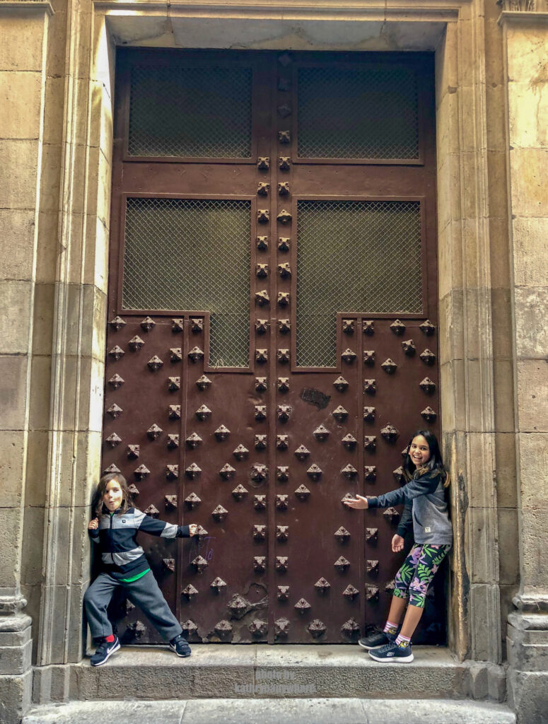 The doors of Lisbon, Barcelona and Paris. This dungeon like brown door my kids are posing in front of, was in one of the pedestrian alleys in the gothic quarter of Barcelona.