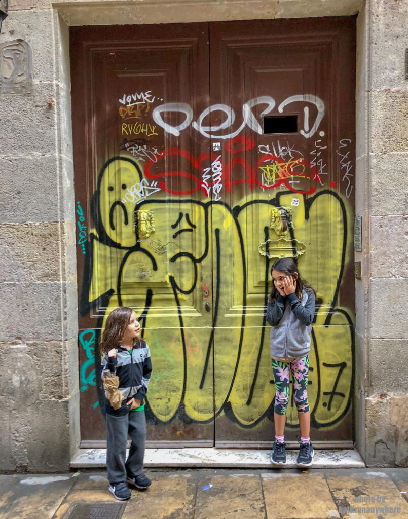 The doors of Lisbon, Barcelona and Paris. This graffiti decorated brown door my kids are posing in front of, was in one of the pedestrian alleys in the gothic quarter of Barcelona. My son had to pee and cut our walking trip short.