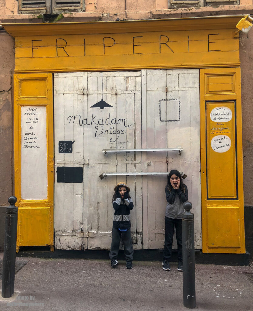 The doors of Lisbon, Barcelona and Paris. This door my kids are posing in front of in Marseille on Rue Vacon, in front of Le Makadam, which appears to be a vintage store. We were too early to find out for sure.