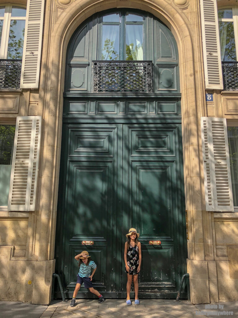 Really tall green door in Paris. This picture with my children was taken in 7th arrondissement neighbourhood in Paris, France