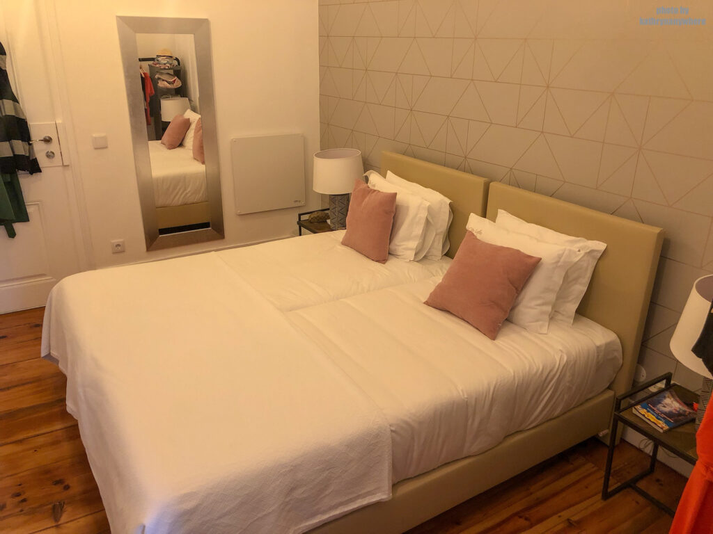 two twin beds in the triple room at City Lofts Guesthouse in Lisbon, Portugal