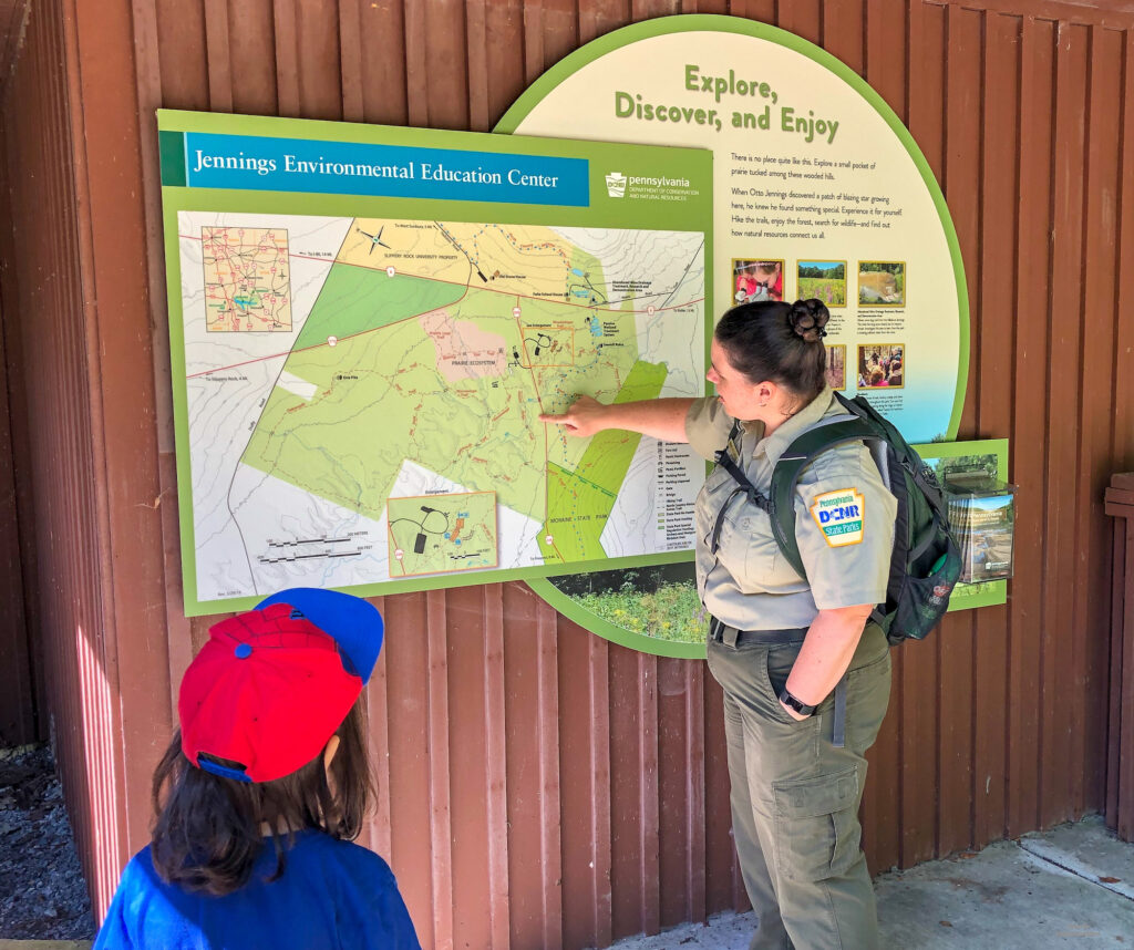 Looking at the hiking trail map outside the visitor's center of Jennings Educational Centre in Slippery Rock, PA