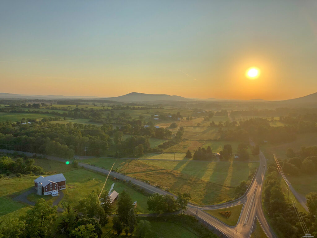 Soaring, Caving, Fly Fishing and Exploring - The Ultimate Family Vacation in State College, PA - The sunrise view of the countryside just outside of State College, PA from a hot air balloon.