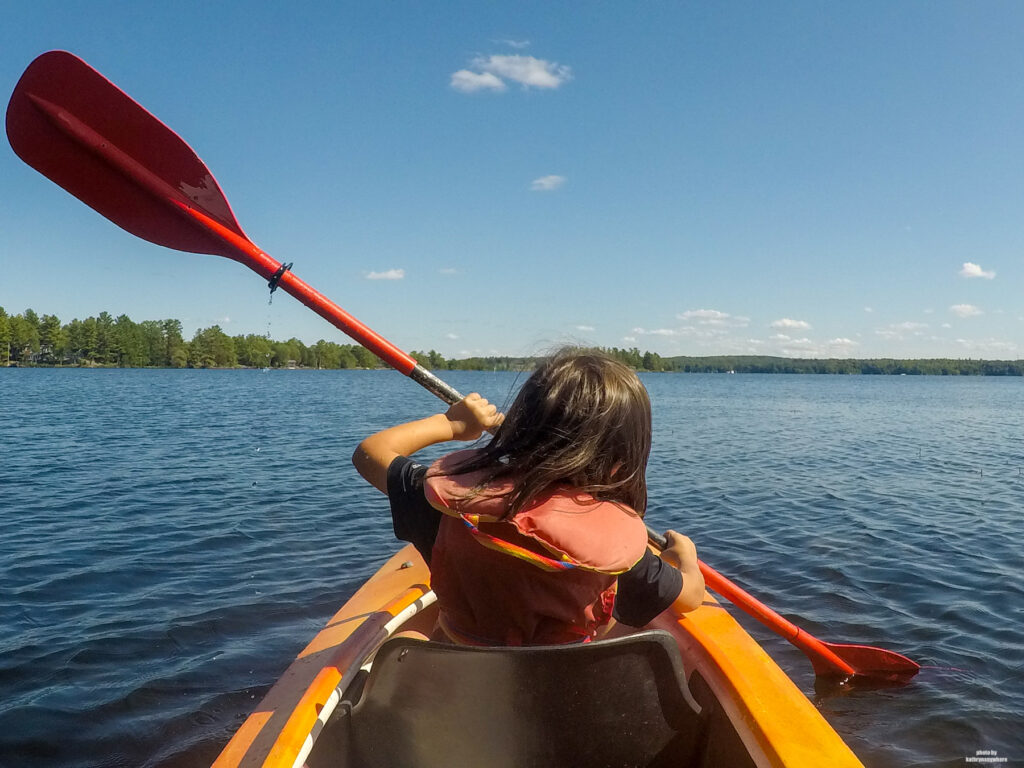My son learning how to kayak on Stoney Lake