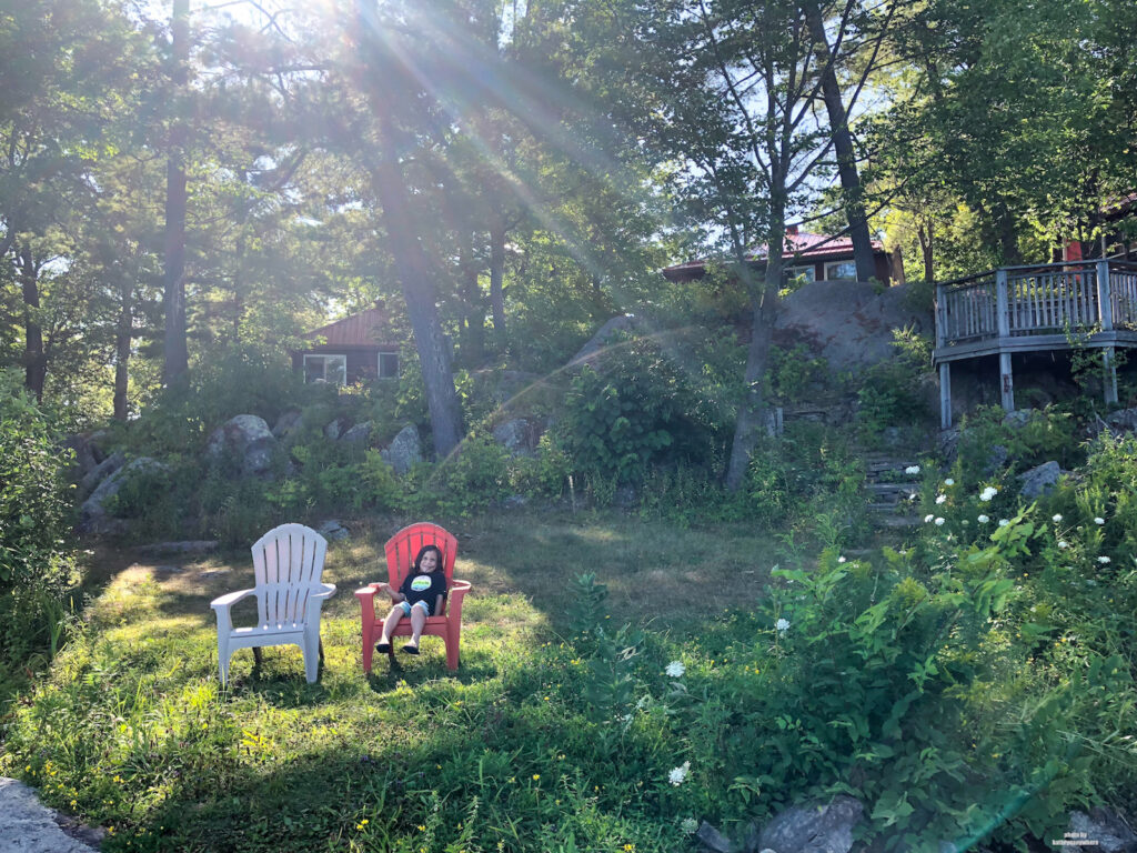 My son sitting outside our 2 bedroom cottage at Viamede Resort
