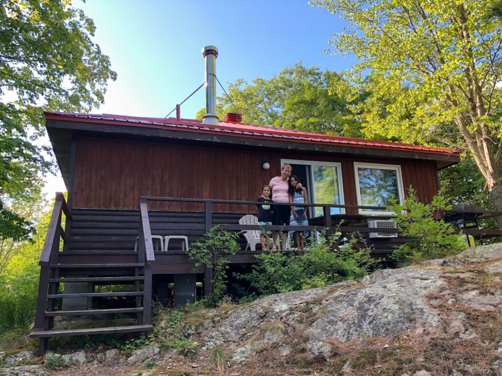My mom and children on a deck of our 2 bedroom cottage at Viamede Resort