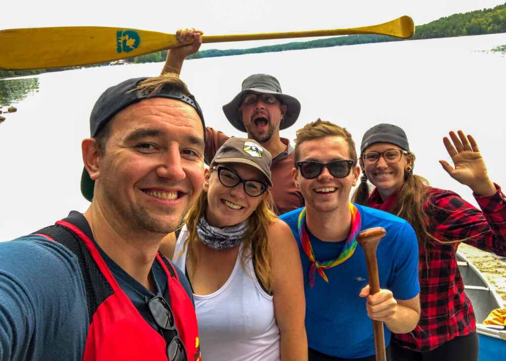 End of canoe portage selfie of Chris, Kat, Kevin, Ryan and Kim. Photo by Chris Mitchell of Traveling Mitch.