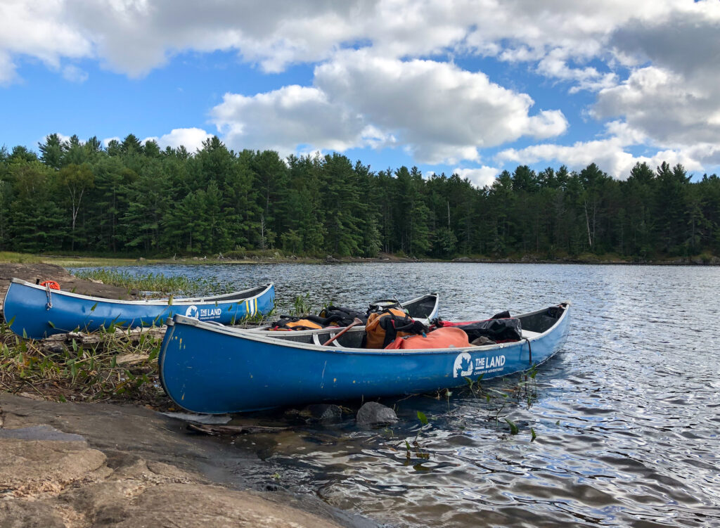 Canoes packed with food barrels and dry bags with tent, sleeping bags ready for push off
