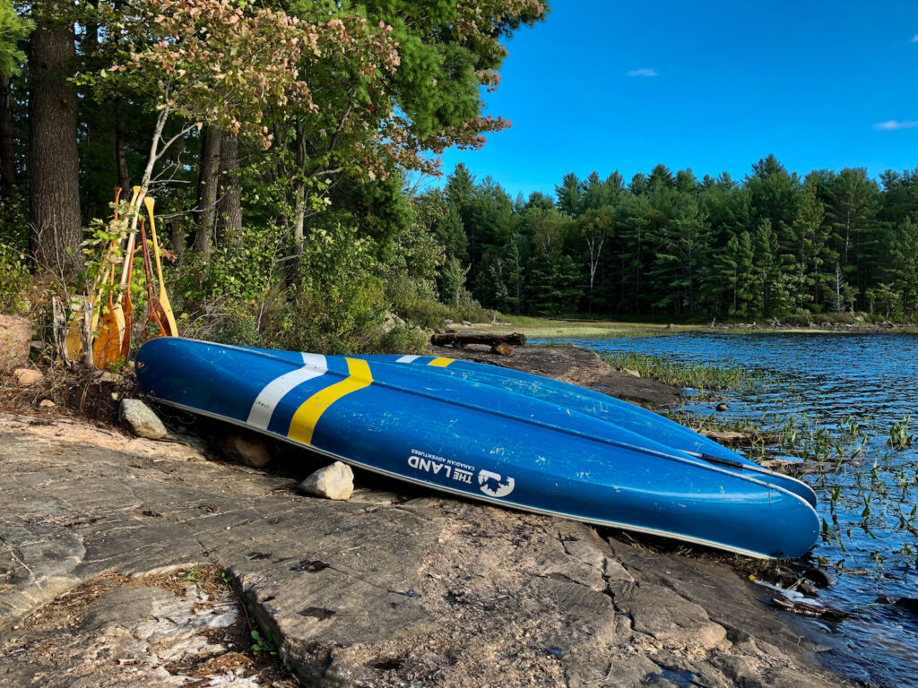 beached canoes on a rock at magic hour