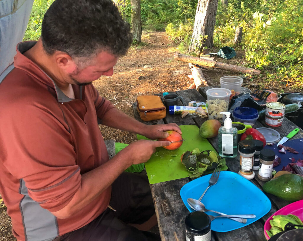 Kevin from Wandering Wagars preparing lunch while camping