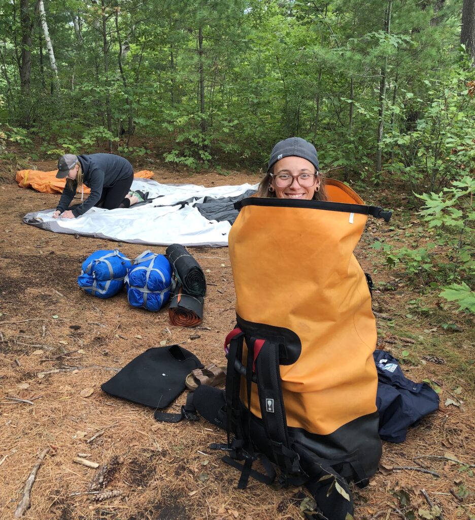 Kat puts together the tent, Kim looks cute stuffed in a dry bag. Photo by Ryan Thomas Woods from Out With Ryan