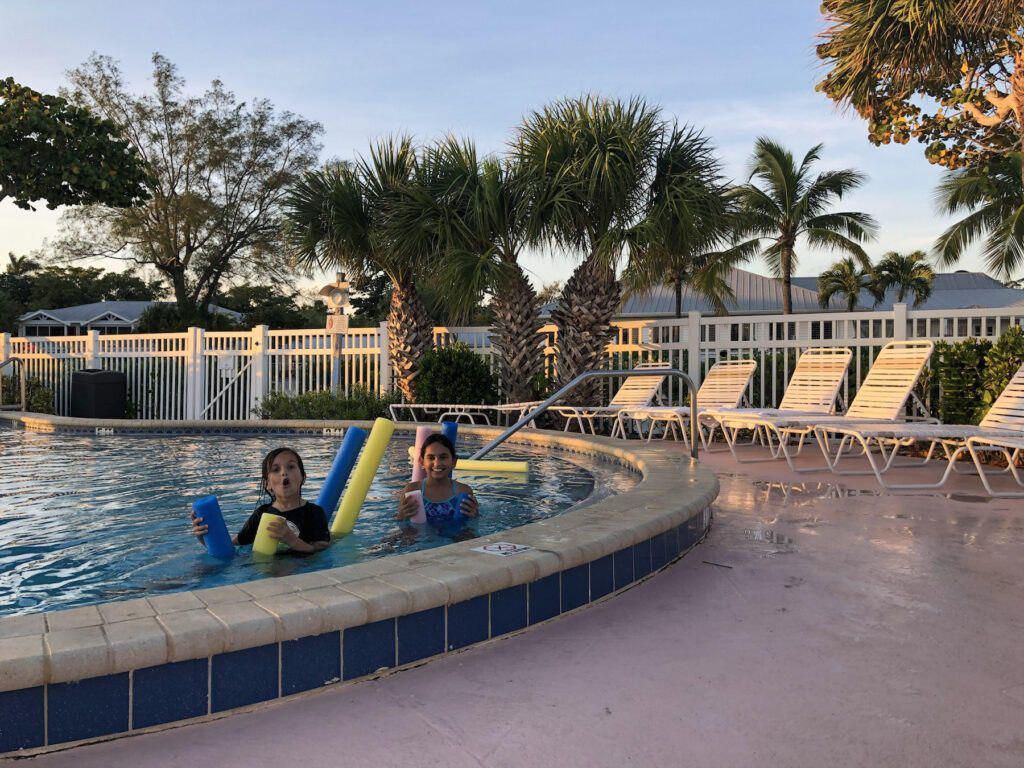 My kids enjoying fun with pool noodles in the pool of Island Inn on Sanibel Island
