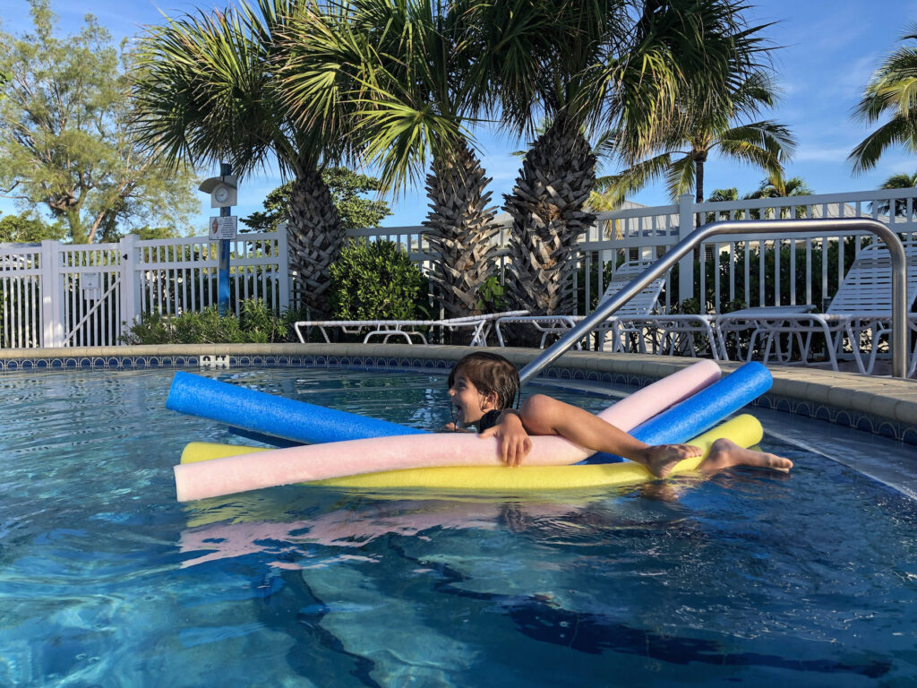 Sanibel Island With Kids - Little Man swimming with his floaties in the morning at Island Inn in Sanibel Island