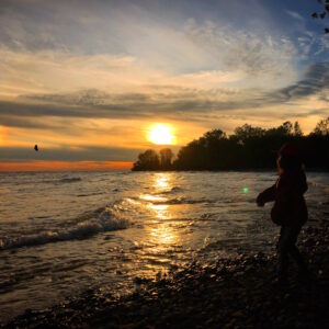 Skipping rocks at sunset at Presqu'ile Provincial Park