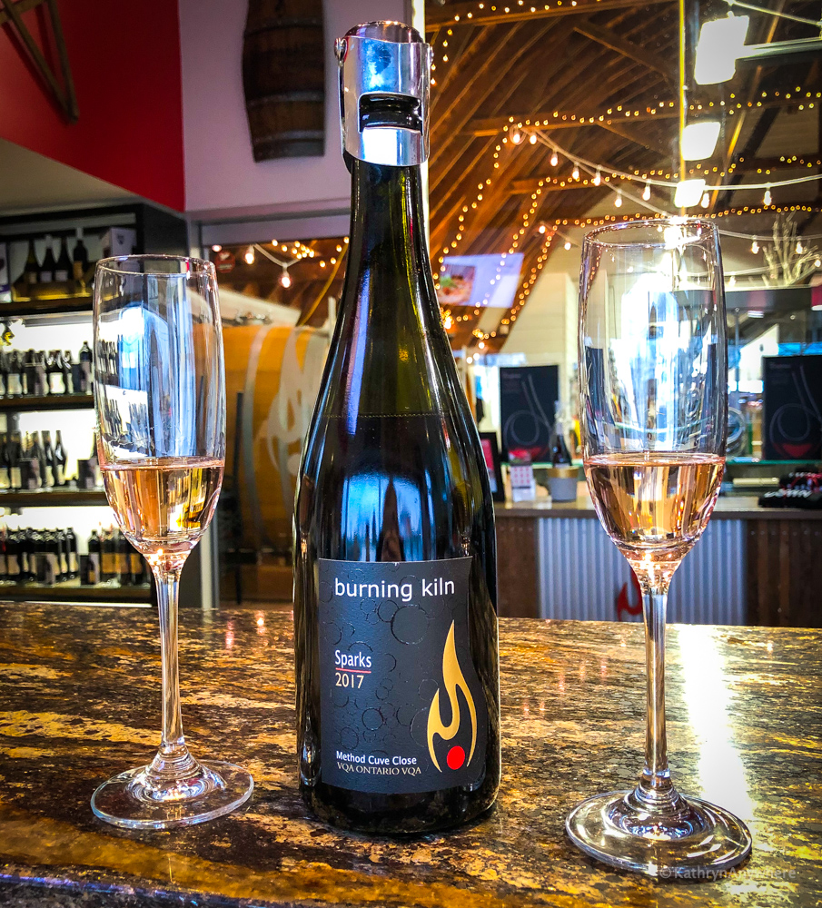 Burning Kiln Sparks bottle with glasses at Burning Kiln winery in Norfolk County