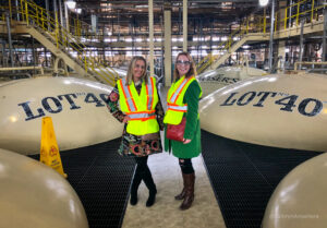J.P. Wiser's Hiram Walker Whisky Tour Kathryn and Kasia with Lot 40 distilling and fermenting still behind them