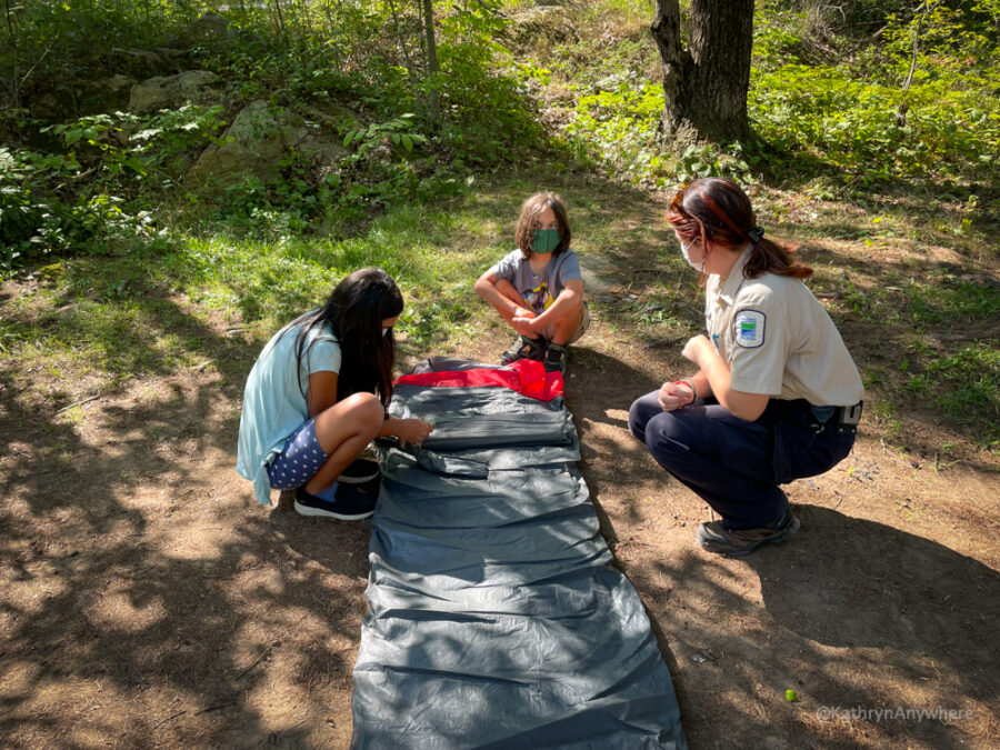 Six Mile Lake Learn To Camp - identifying the right spot to set up the tent and unrolling the tent.