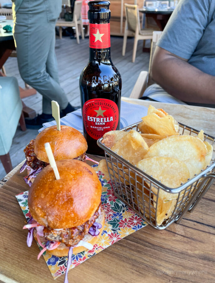 Estella Damm and Chicken Katsu Sando - Buttermilk Fried Chicken, Coleslaw, Gochujang BBQ Sauce at Harriet's rooftop patio in Toronto