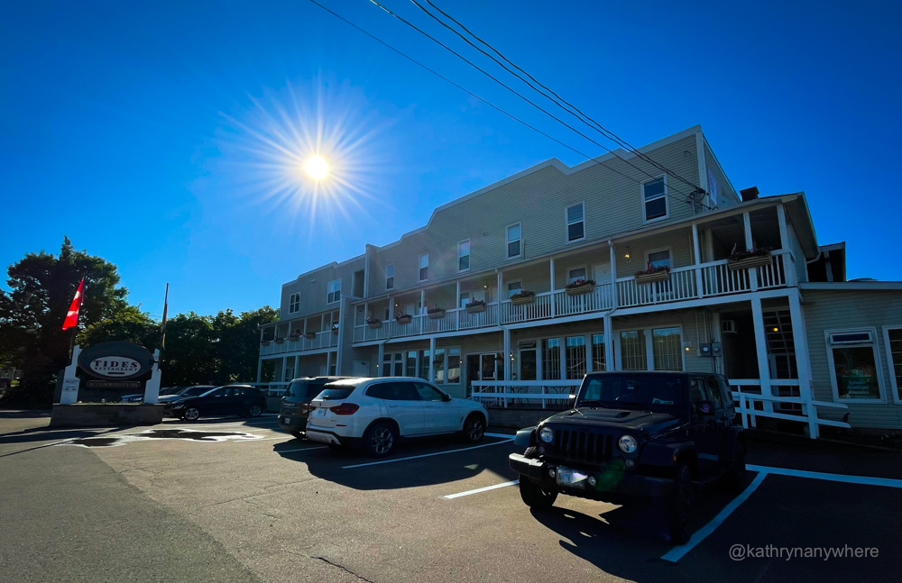 Exterior of the Alma Parkland Village inn with sun flare