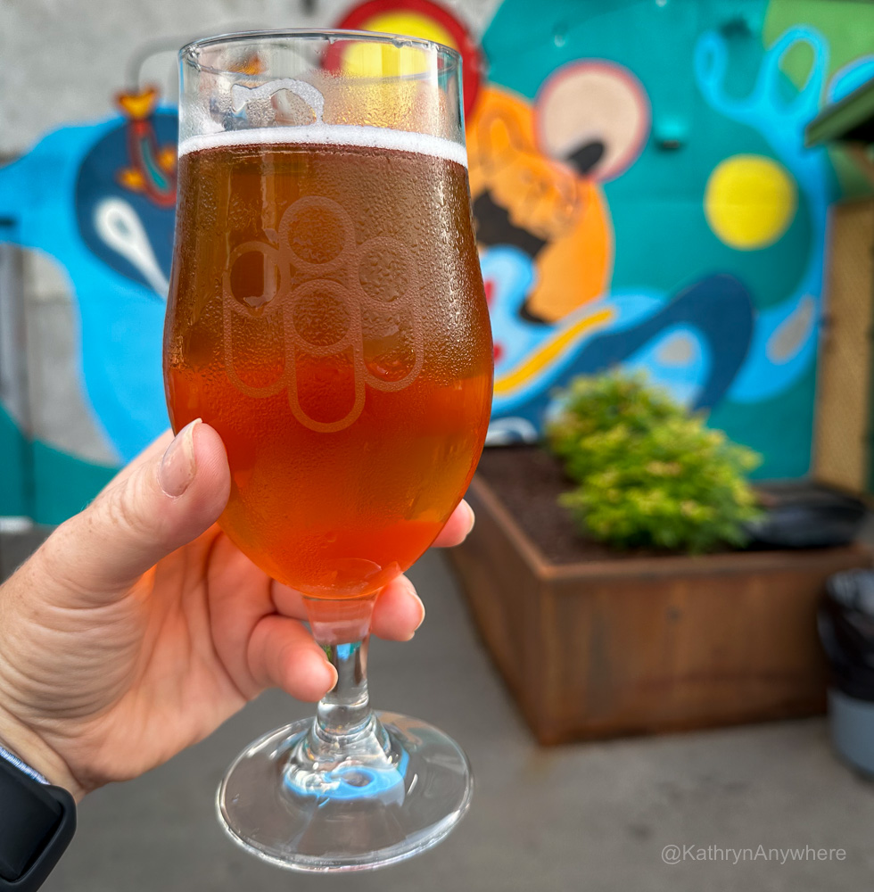Lakehead Beer Company lager draft in a glass exterior against a mural