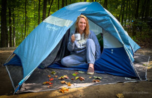 How to Save Money Camping, Having morning coffee while tent Camping in Silver Lake Provincial park, Ontario