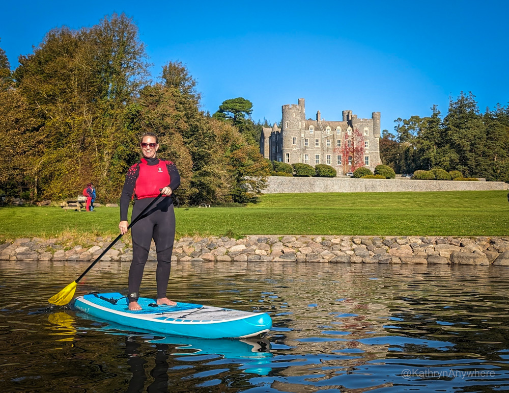 Stand Up paddle boarding in front of Castlewellan Castle on her Northern Ireland girl's trip
