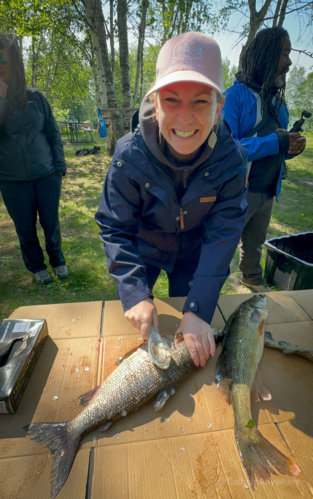 kâniyâsihk Culture Camp Kat scaling a fish