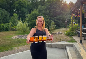 Brauwerk Hoffman beer flight with happy Kat at a Tap and Cork Route stop in Pontiac Region of Quebec